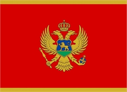 [ai] The flag of Montenegro featuring a red background with a gold border. In the center, a double-headed eagle is depicted in gold with a blue shield on its chest, displaying a lion, surrounded by a crown.